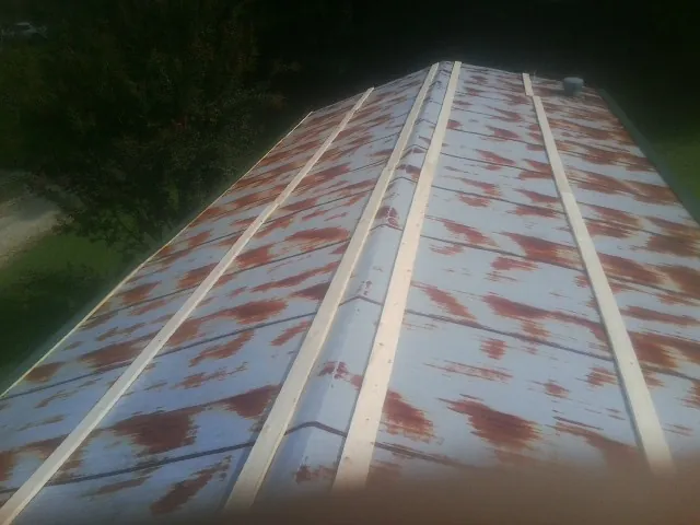 Rusted metal roof panels with new wood purlins before replacement — Storm Damage Roof Repair in Mastic by Roofing Brothers